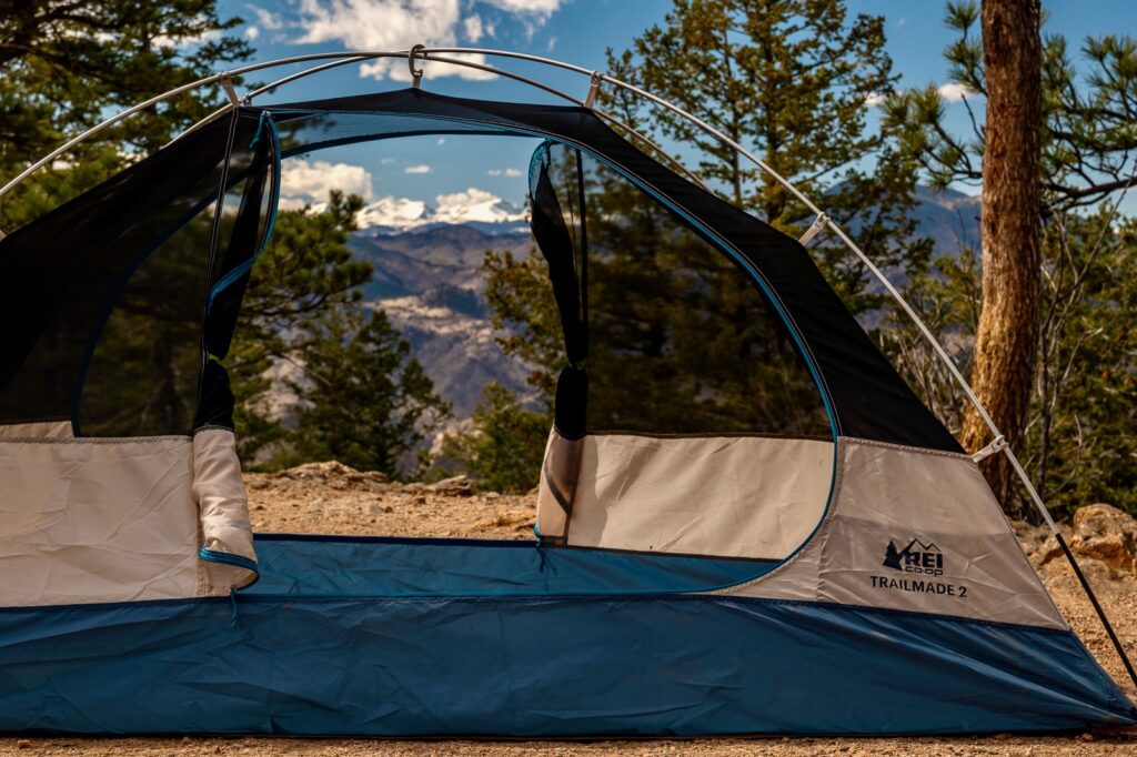a tent is setup with no fly, doors open, and a mountain view
