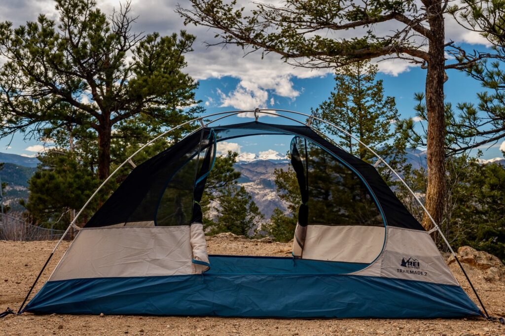 a tent is setup with no fly, doors open, and a mountain view