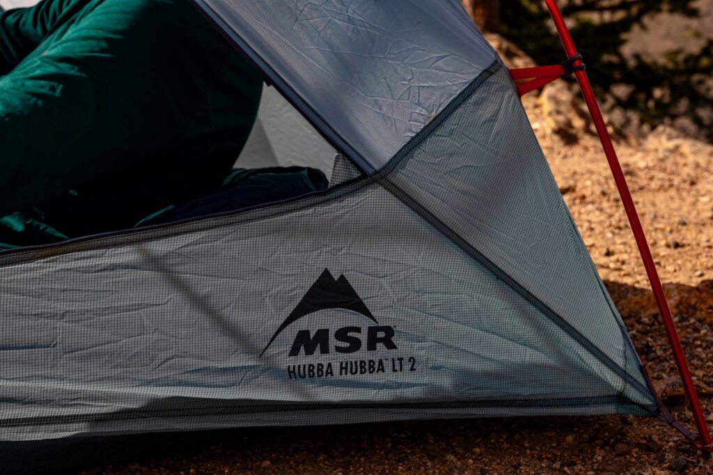 a close up of the corner of a tent reading "msr hubba hubba LT 2"