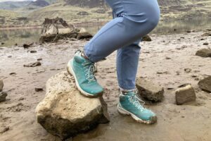 Hiker wearing the Oboz Katabatic LT Mid Gore-Tex Hiking Boots on a riverbank