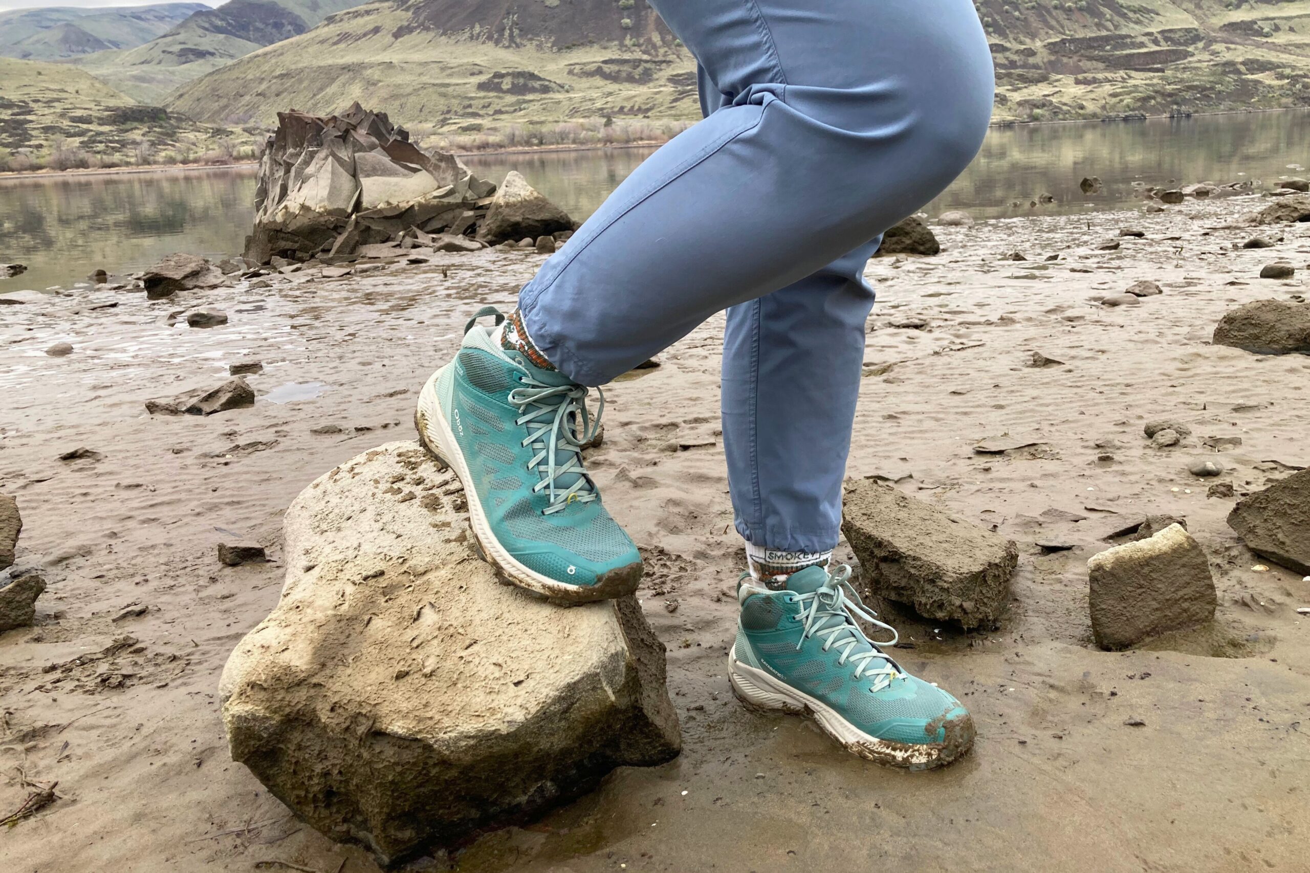 Hiker wearing the Oboz Katabatic LT Mid Gore-Tex Hiking Boots on a riverbank