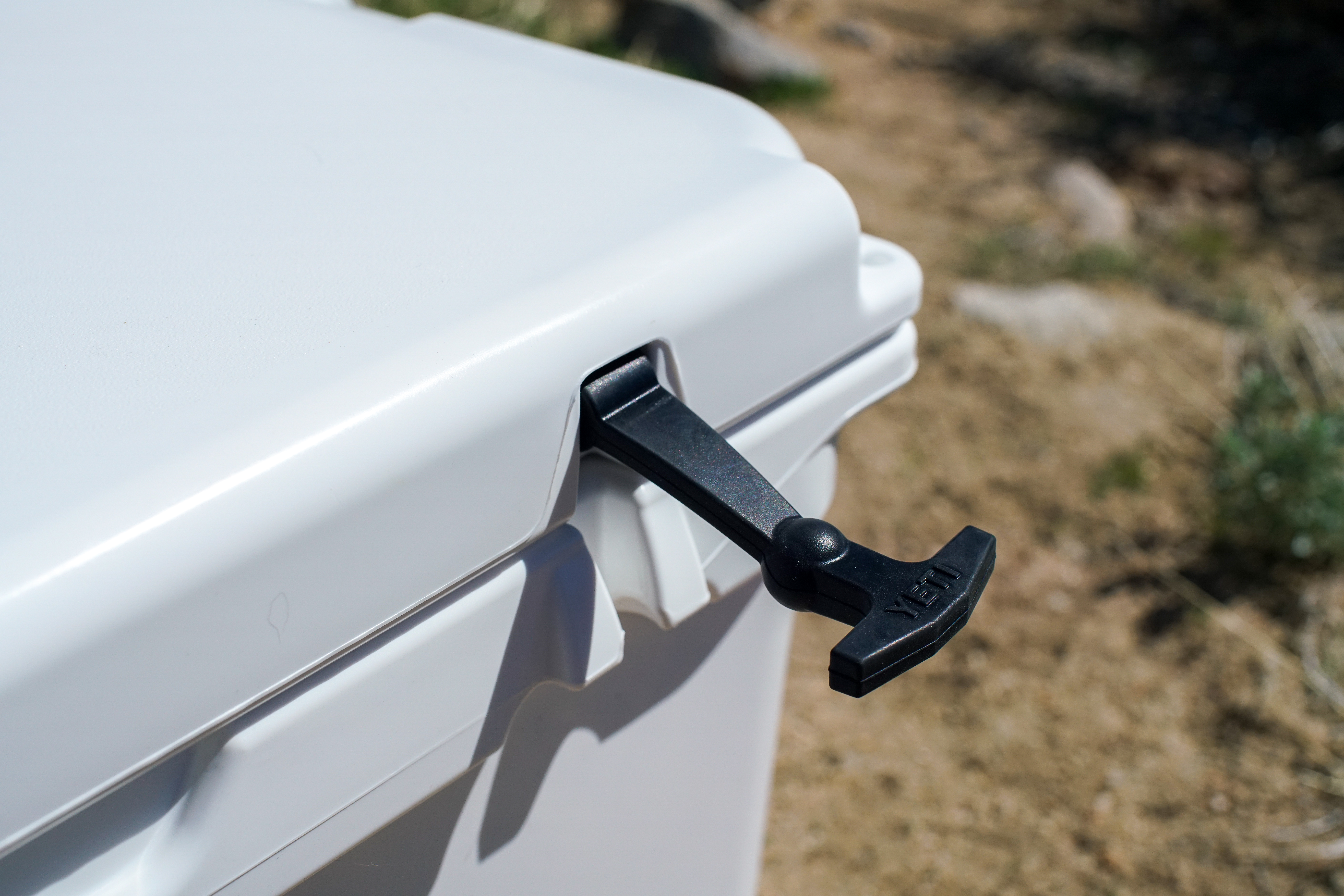 A close up of a t-latch on the YETI Tundra 65 cooler.