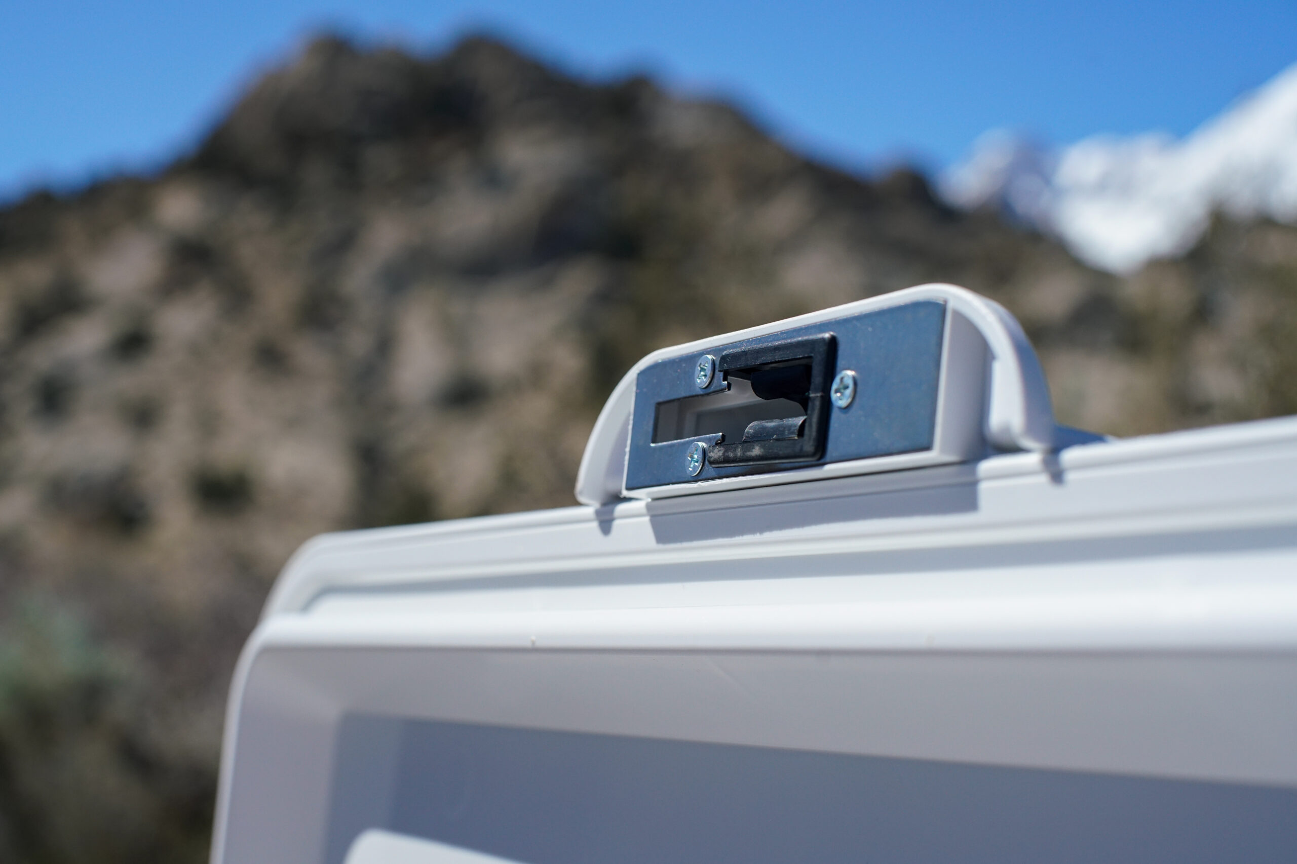A close up of the Coleman Steel Belted cooler's lid latching system.