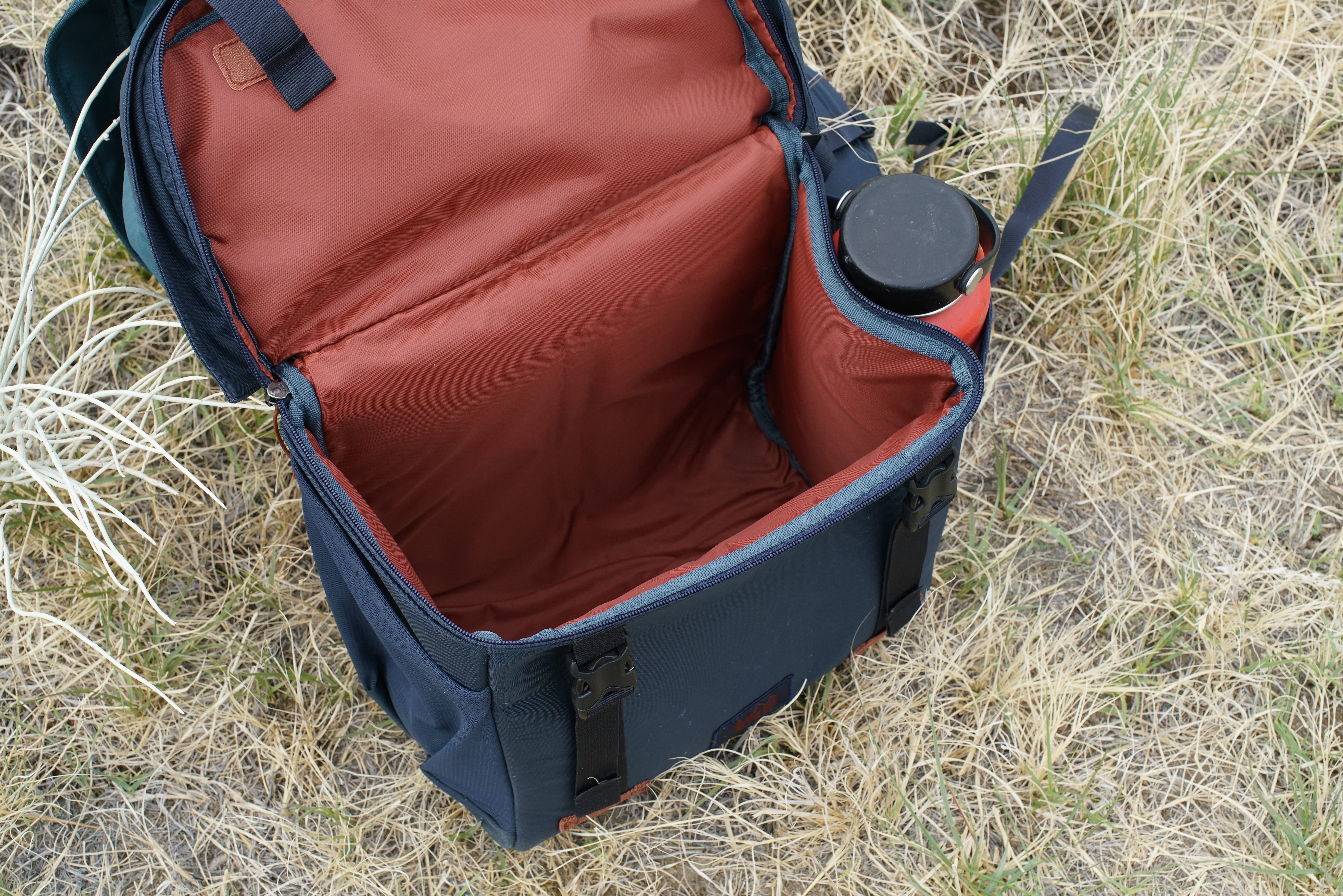 A close up looking down at the open compartment at the bottom of the REI Cool Trail Split Pack.