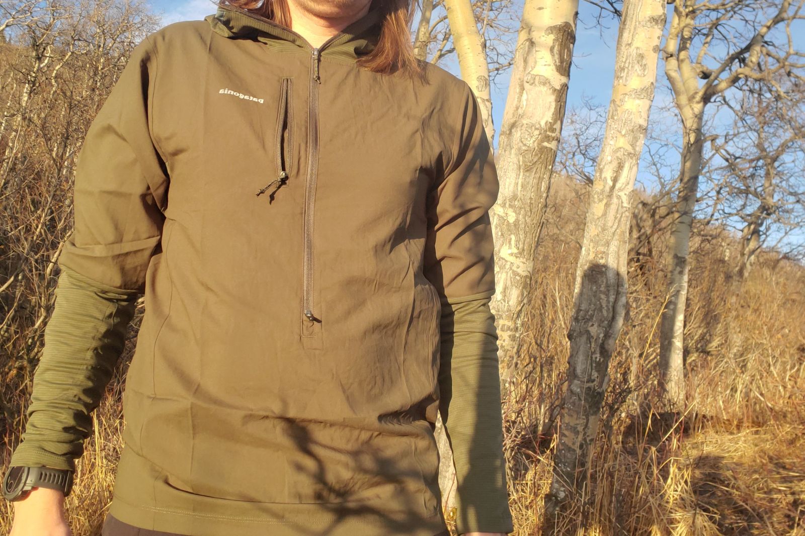 A close up of the chest of a green windbreaker.