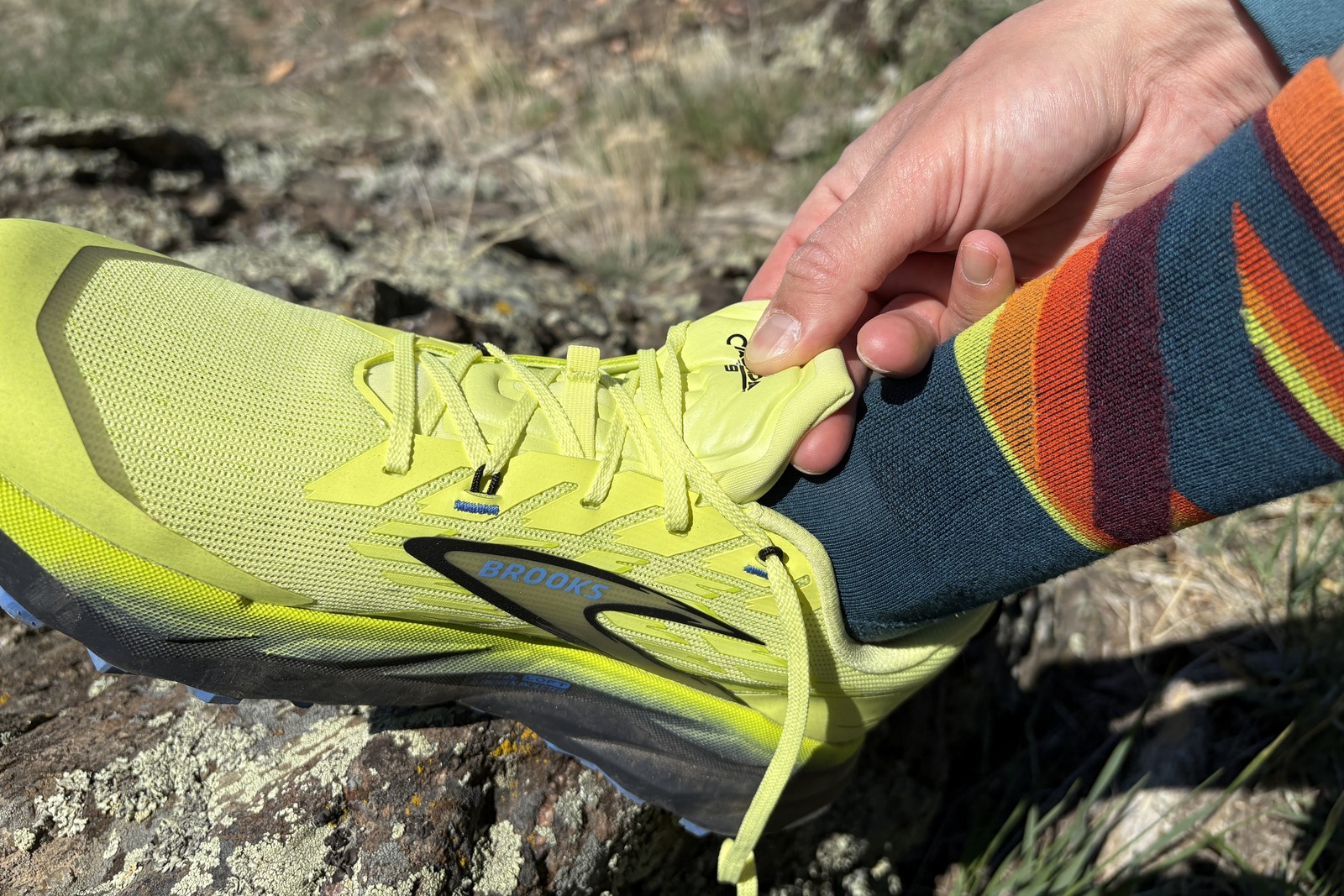 Finger squeeze the tongue of a running shoe.
