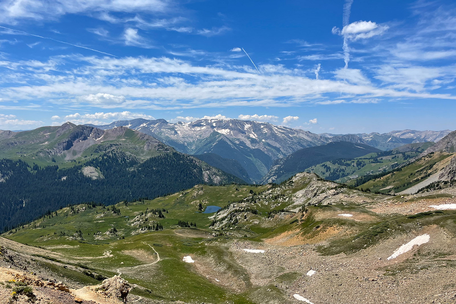 Views of a large valley with mountains in the distance.