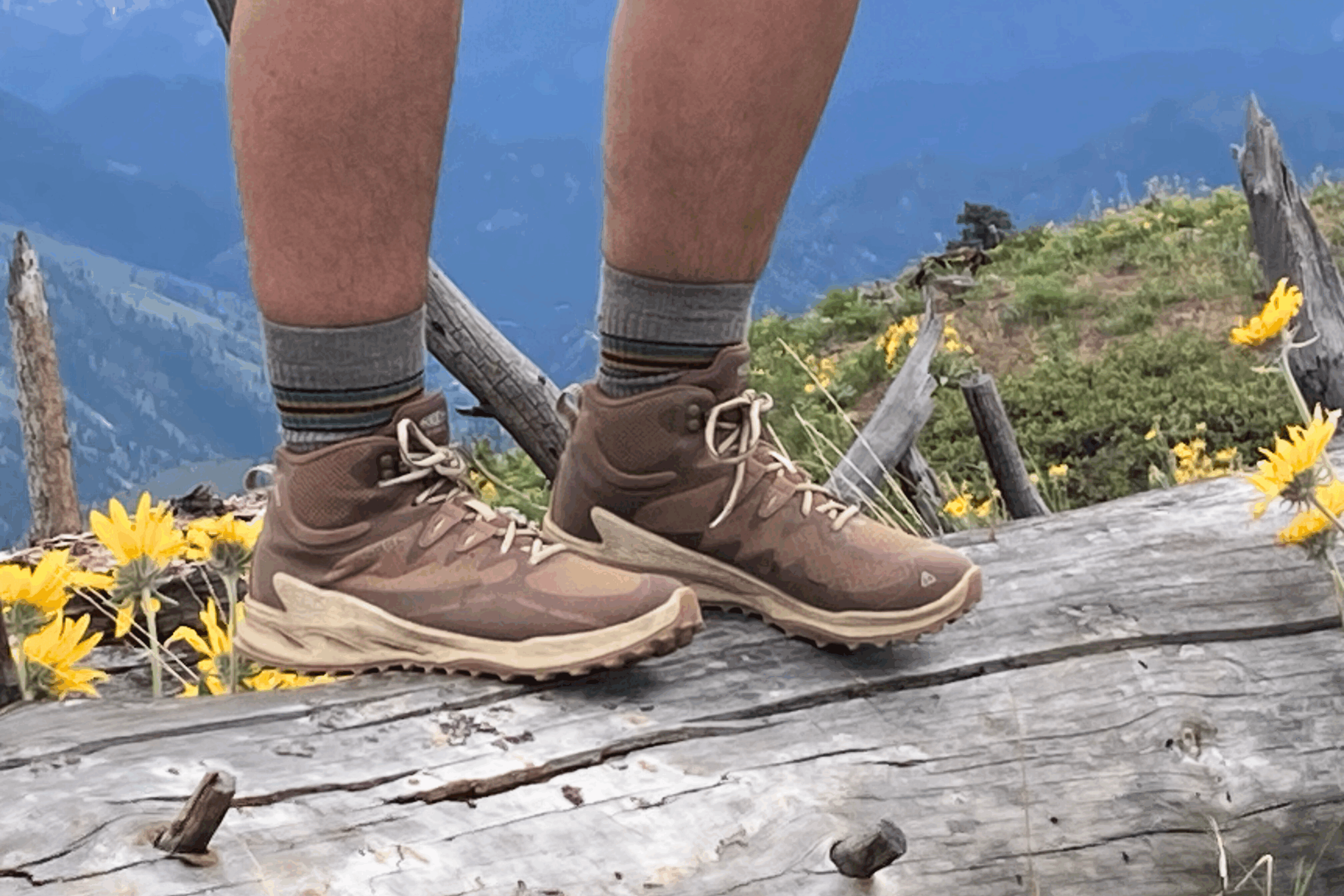 Hiker standing on a log wearing the Keen Zionic Waterproof Women’s Hiking Boots