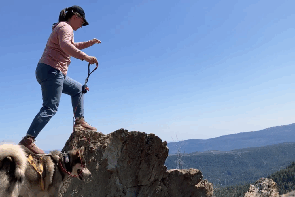Hiker crossing over a rocky ridge wearing the Keen Zionic Waterproof Women’s Hiking Boots
