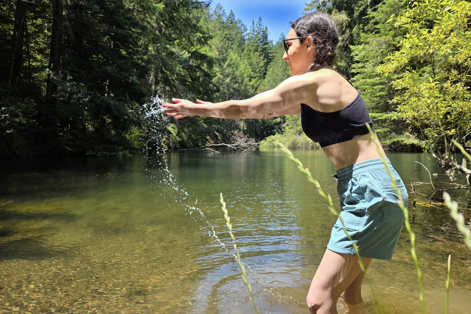 Woman playing in the water while testing the quick dry capabilities of a pair of hiking shorts.