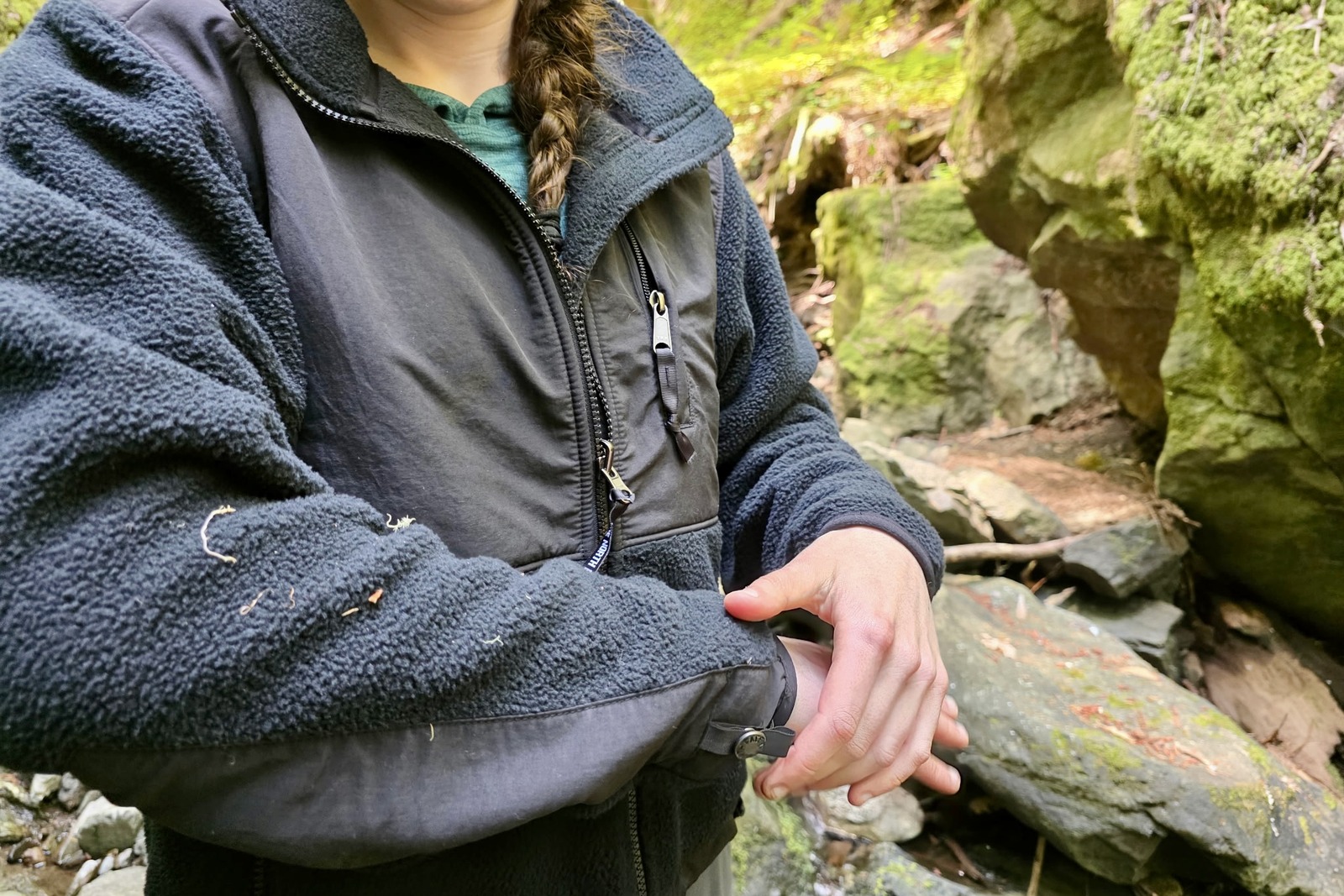 Close up showing the debris cling on a black fleece jacket