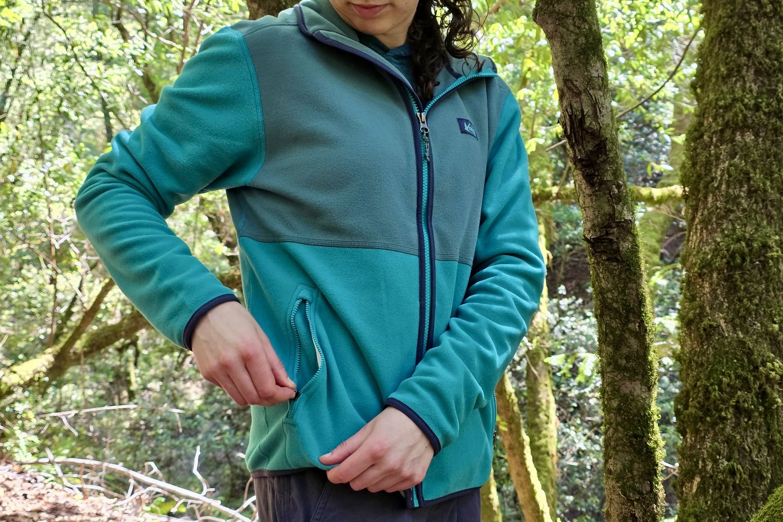 Close up showing the zippered hand pockets of a fleece jacket.