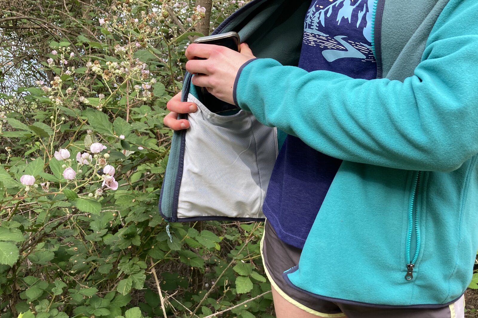 Close up showing the interior mesh pocket of a fleece jacket.