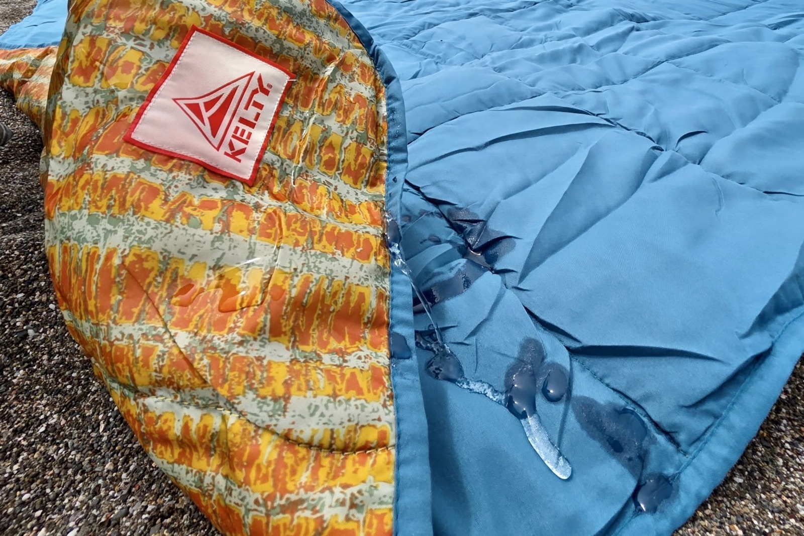Water drips down a blanket and is absorbed into the material.