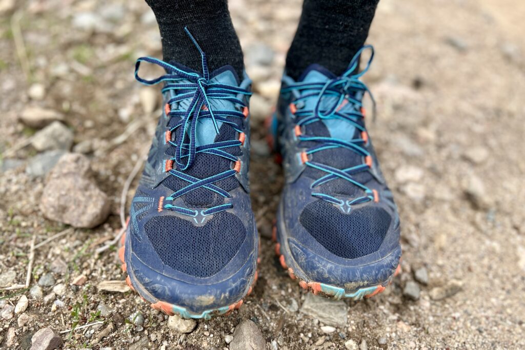 Close up of a person's feet wearing a pair of trail runners.