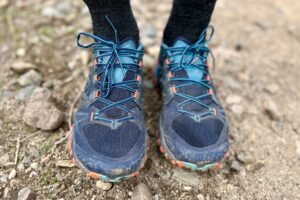 Close up of a person's feet wearing a pair of trail runners.