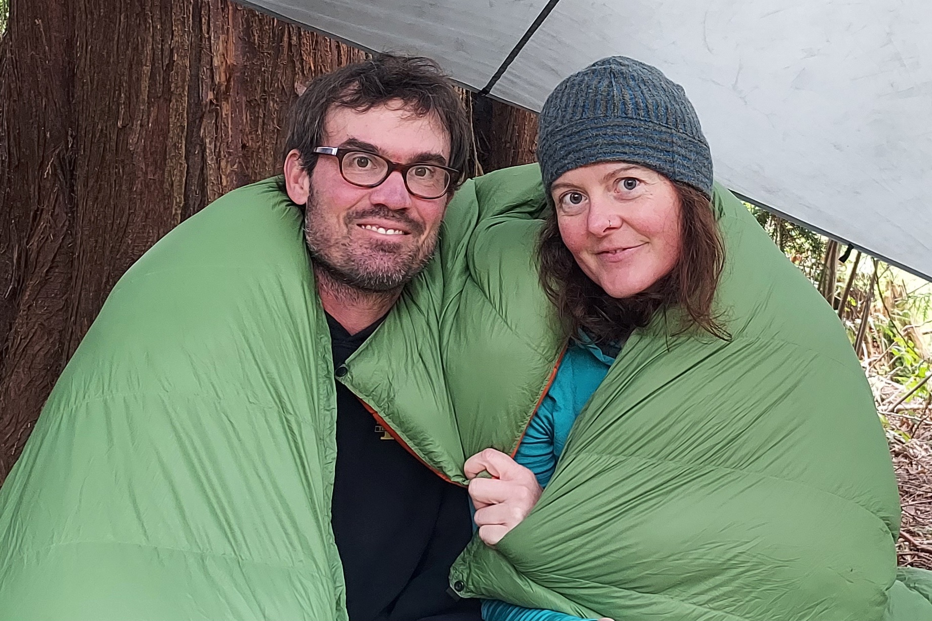 Enlightened Equipment Accomplice Quilt with couple under tarp