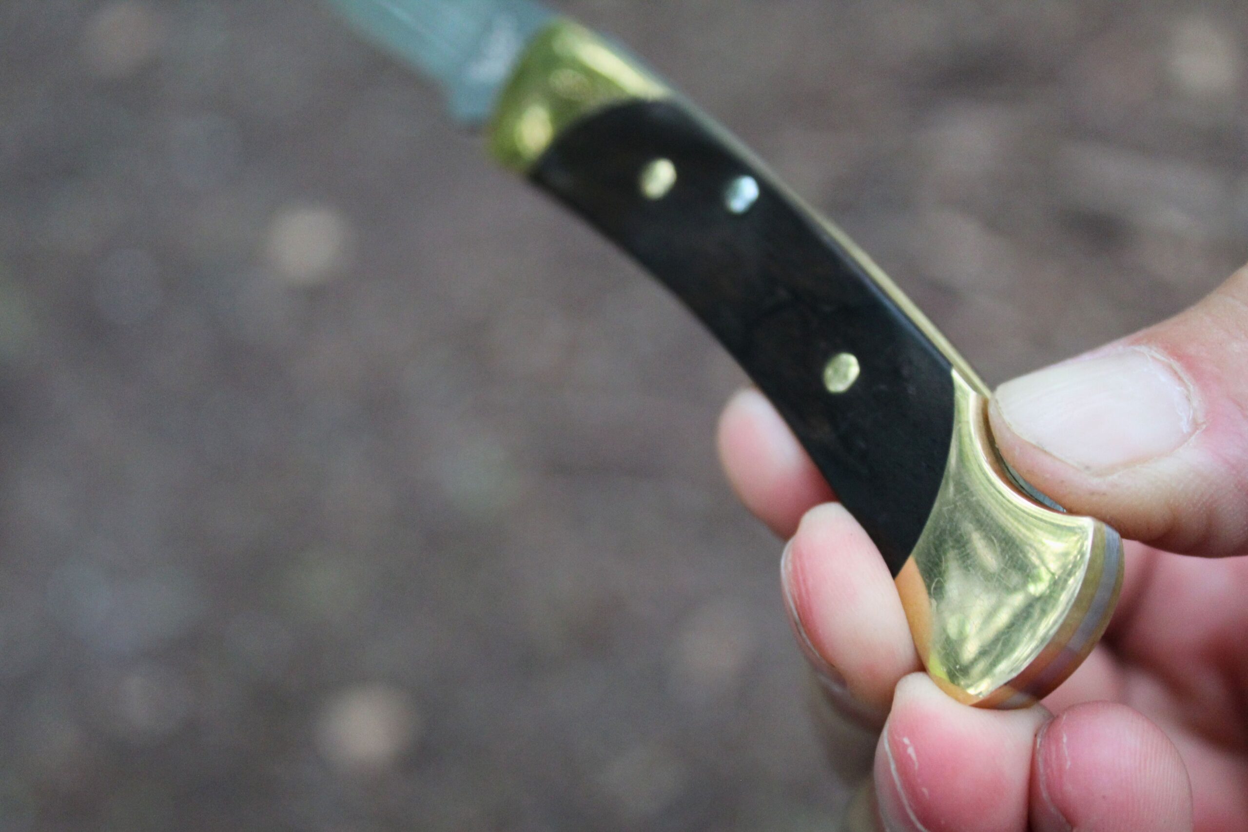 Pressing on the back lock of the Buck Knives 055 Pocket Knife