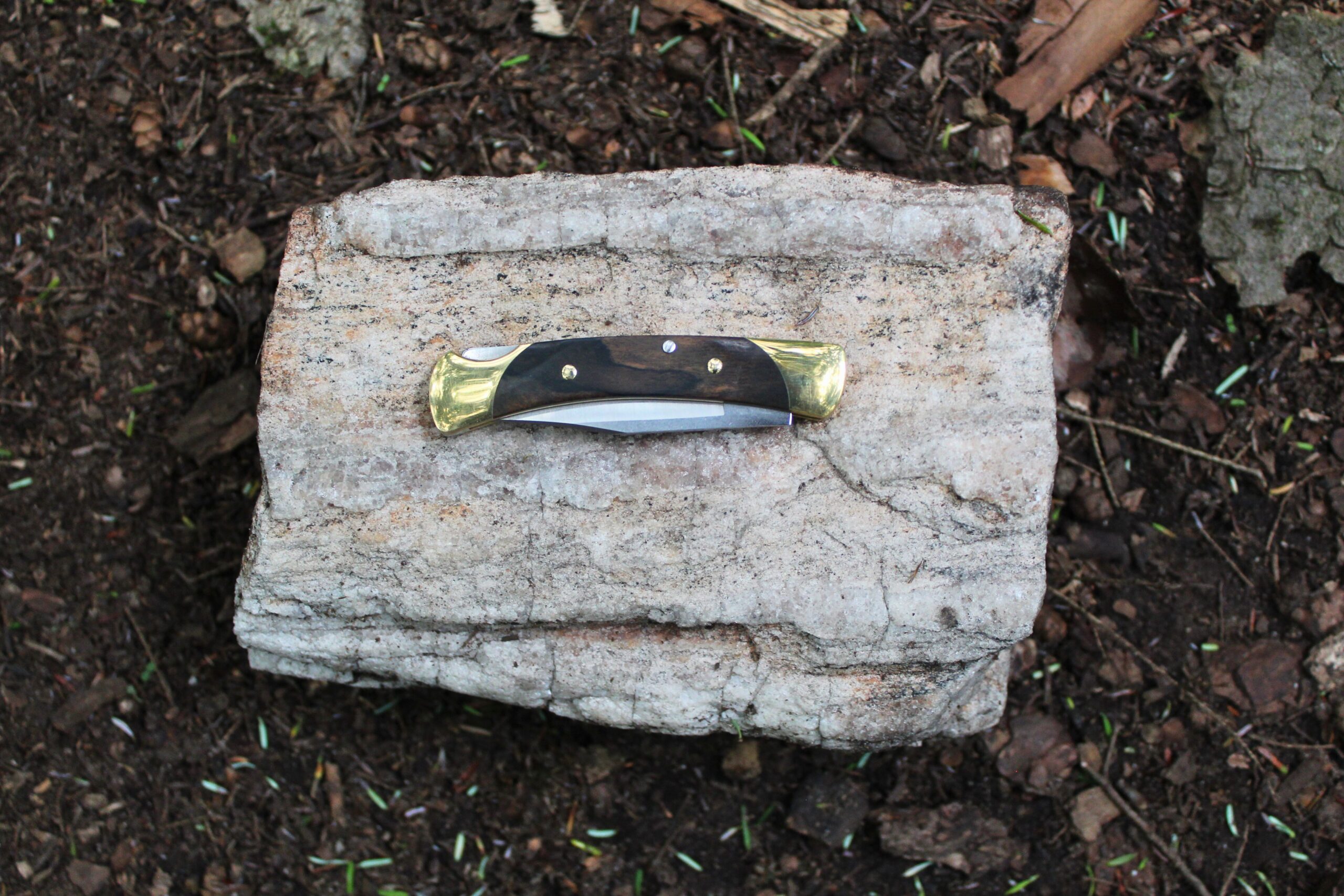The Buck Knives 055 Pocket Knife closed on a rock