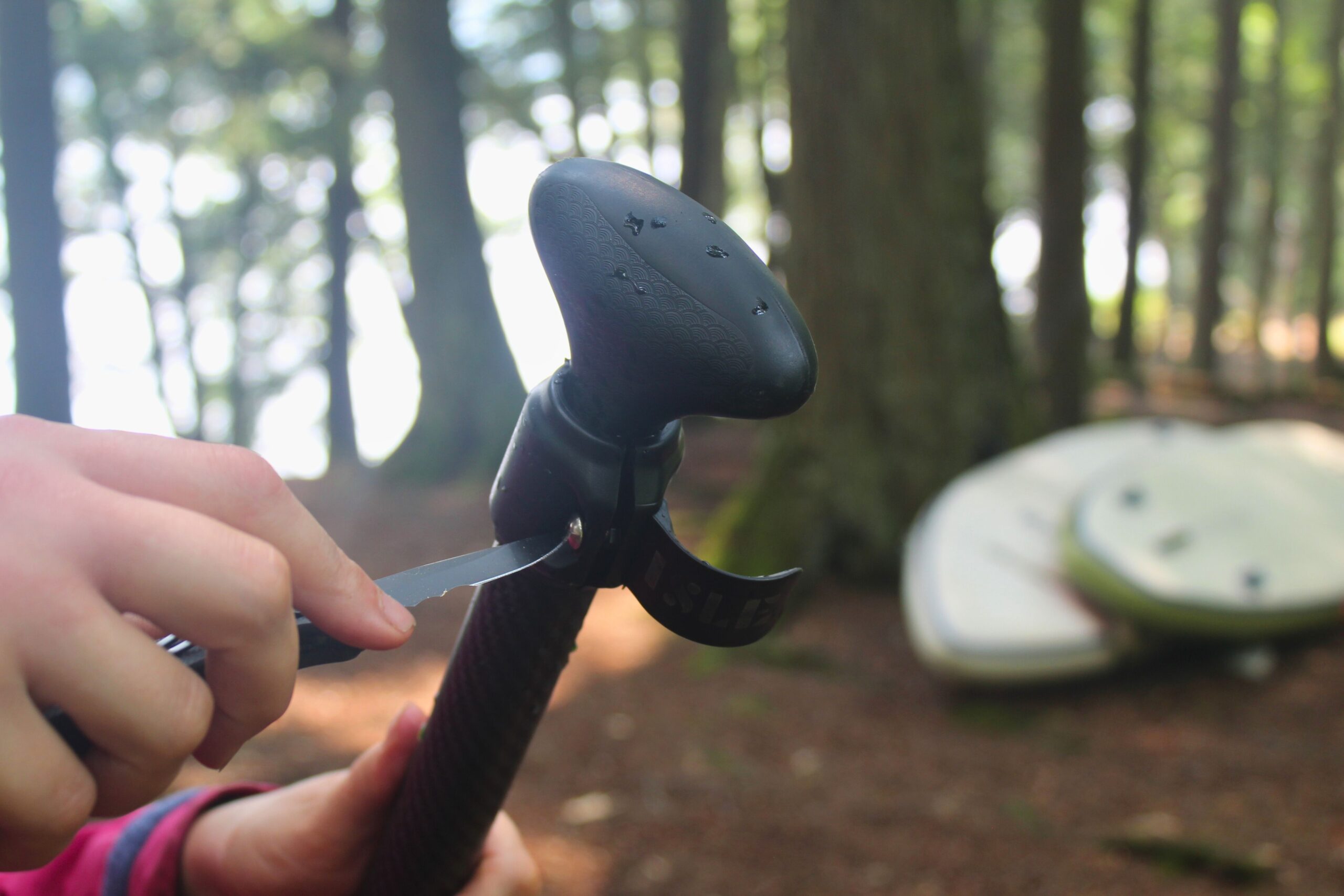 Using the CRKT Drifter Pocket Knife to tighten the top screw on a paddle