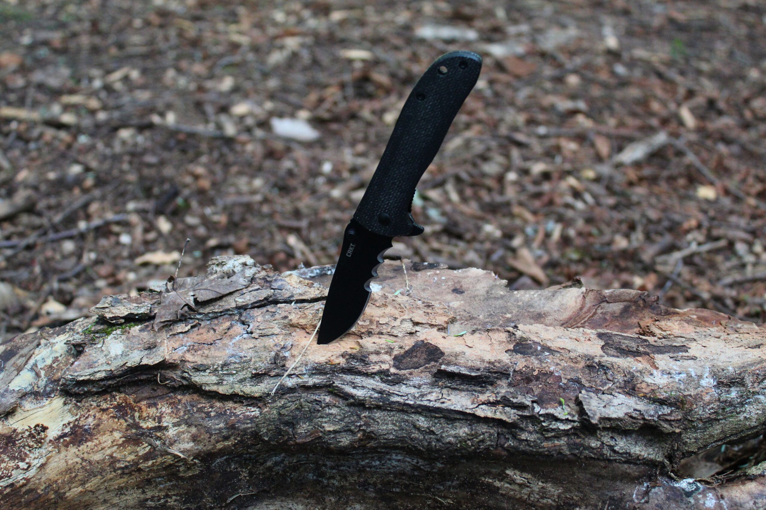CRKT Drifter Pocket Knife stuck in a log
