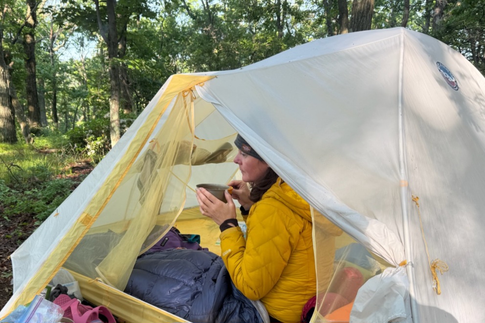 Hiker drinking coffee in the Hyperlite Mountain Gear 20 in camp on the Appalachian Trail