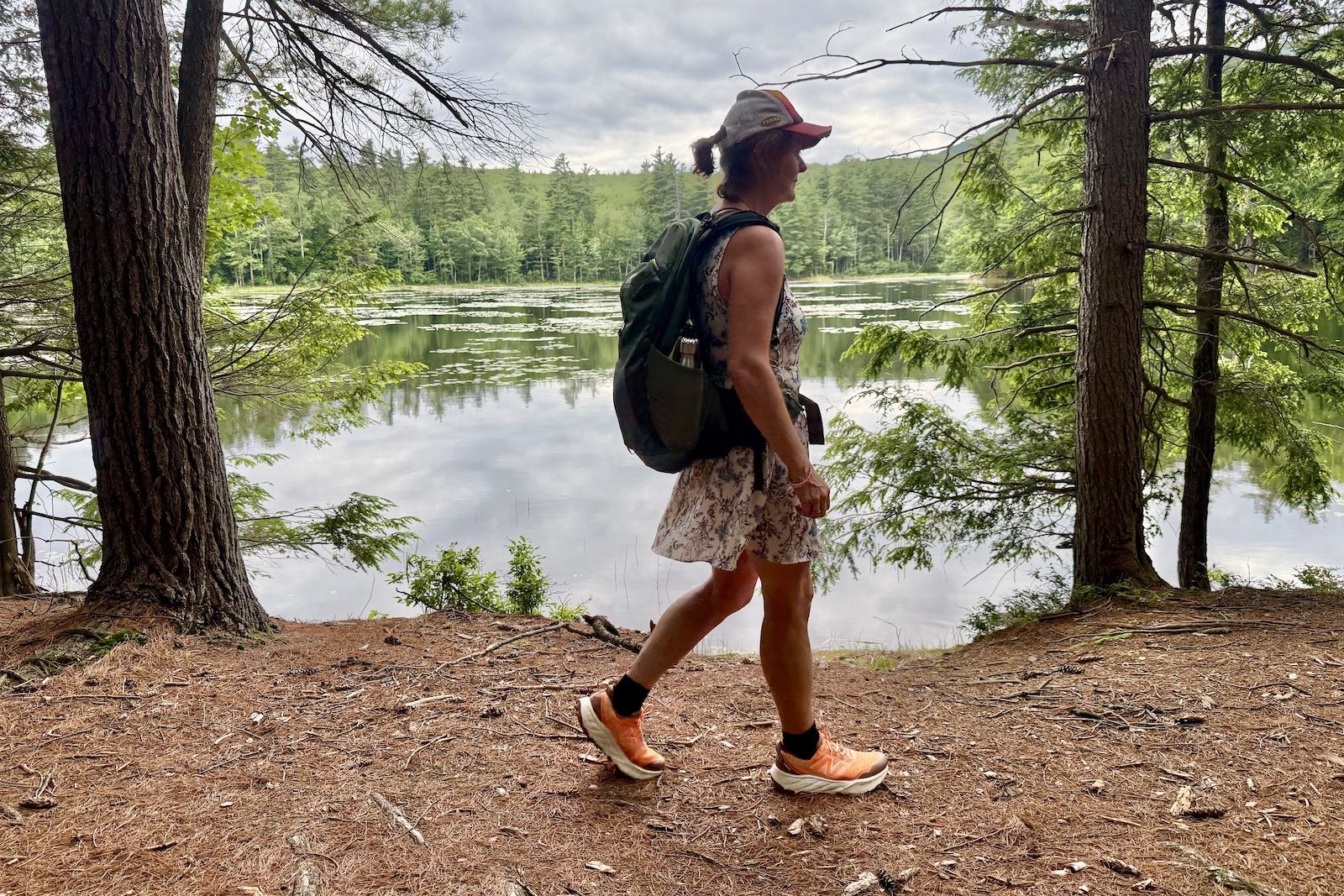 Hiker along a pond in the New Balance Fresh Foam Hiero 9