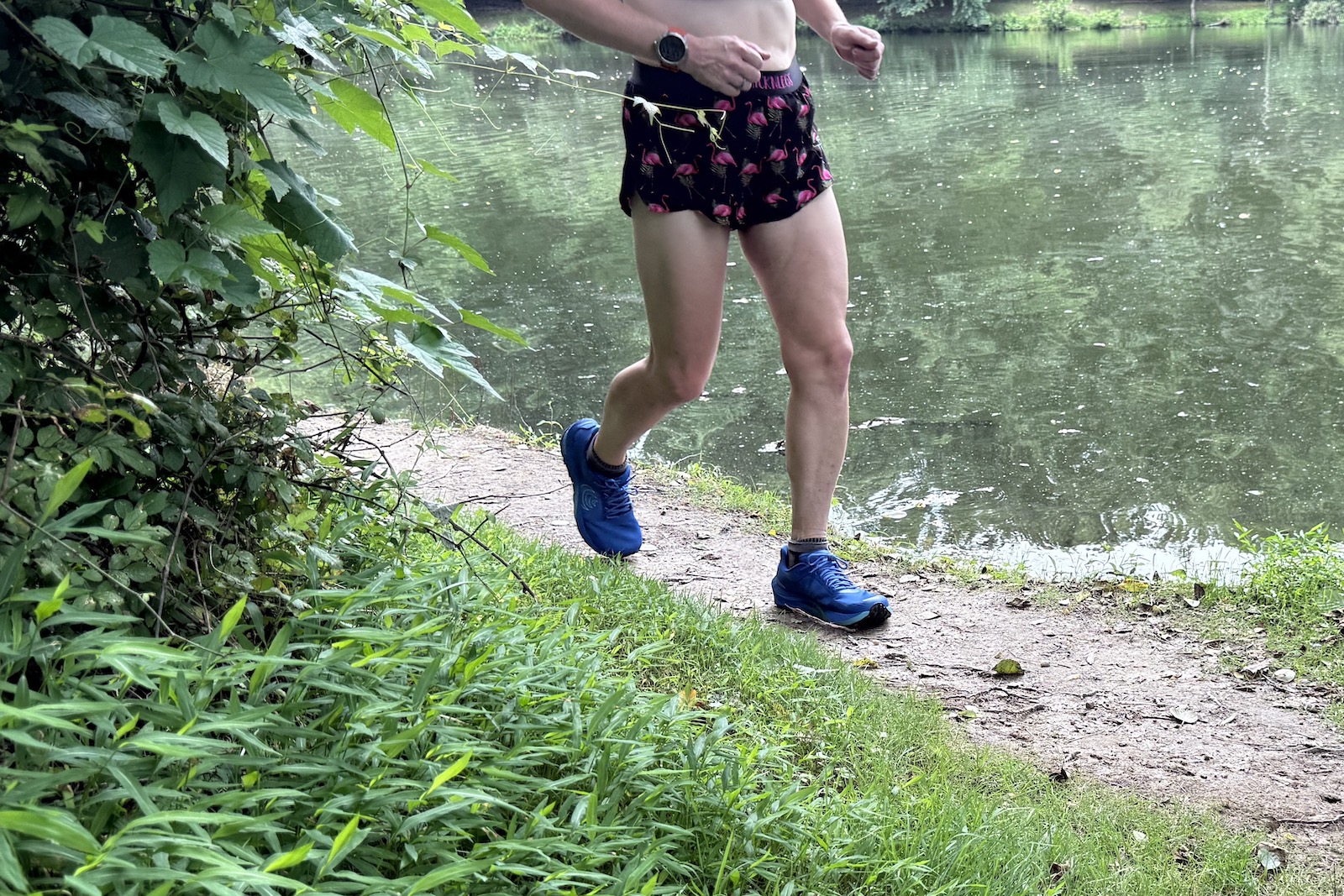 The Topo Athletic MTN Racer 4 on a runner by a pond
