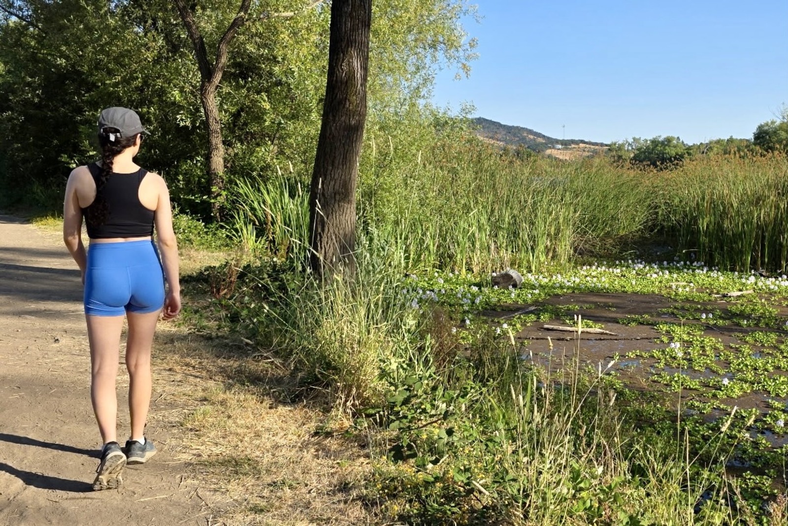 A woman walks along a maintained trail in her Lululemon shorts.