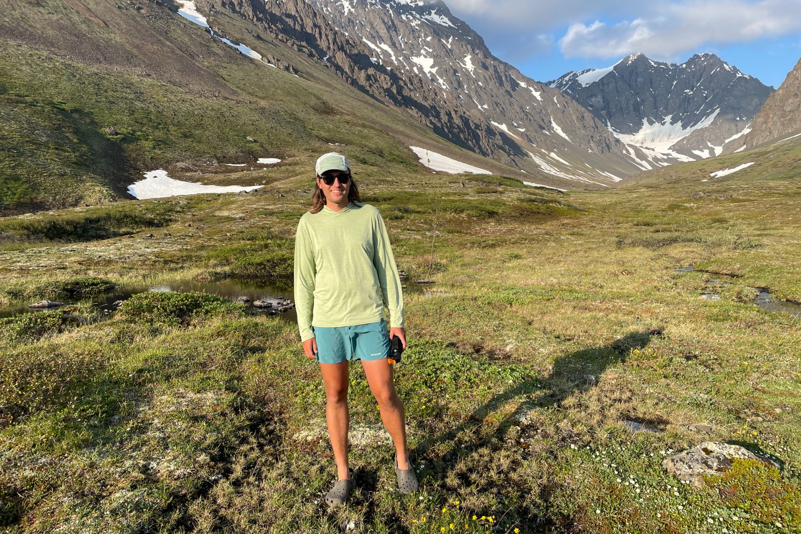 A man stands in an alpine valley.