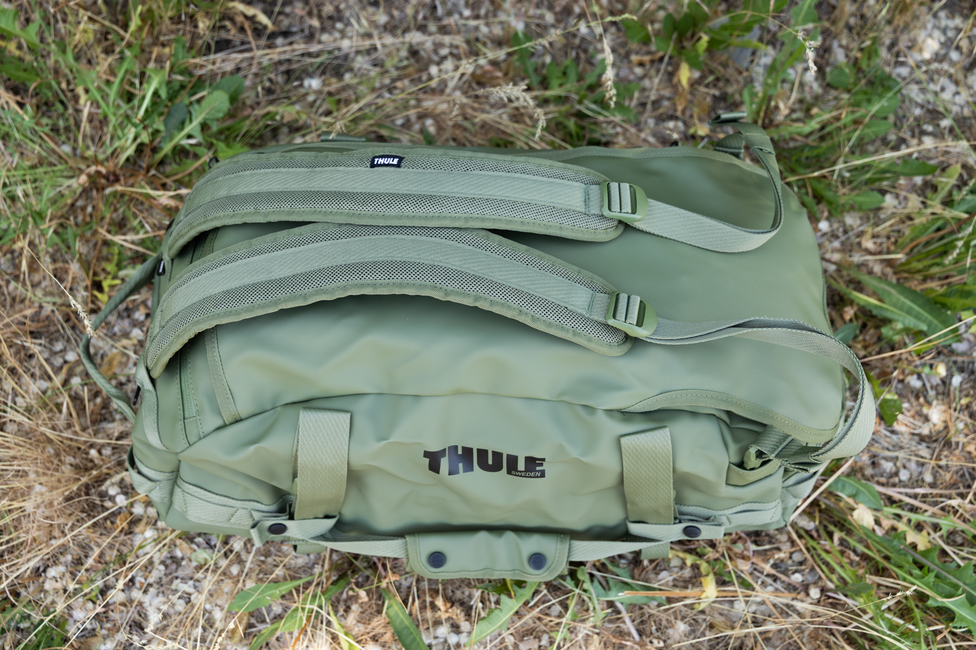 A 3/4 view of the Thule Chasm. You can see the shoulder straps attached, smooth outer materials, and duffel handles secured to the sides via snap loops.