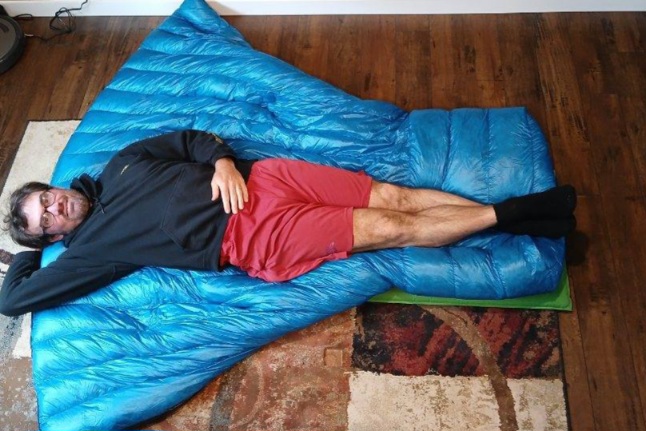 The ZPacks 20F (-7C) Twin Quilt with one person for scale