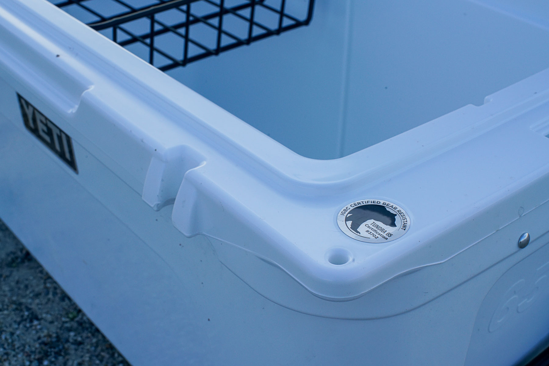 A closeup of a corner of the YETI Tundra 65 cooler with a sticker marking its IGBC certification.