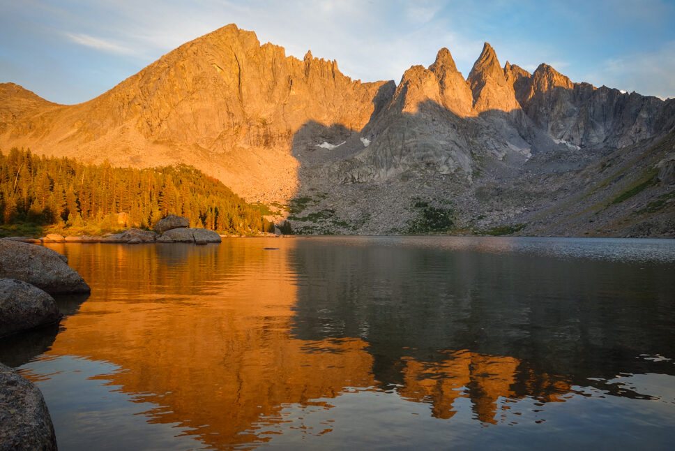 mountains during alpenglow reflected in lonesome lake in the cirque of the towers