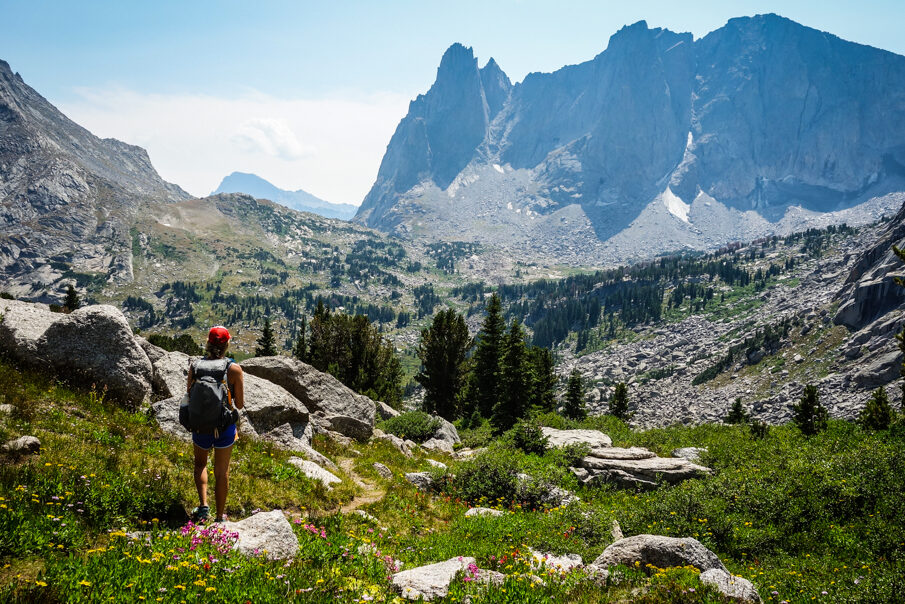 a backpacker looking at the wind river range in montana