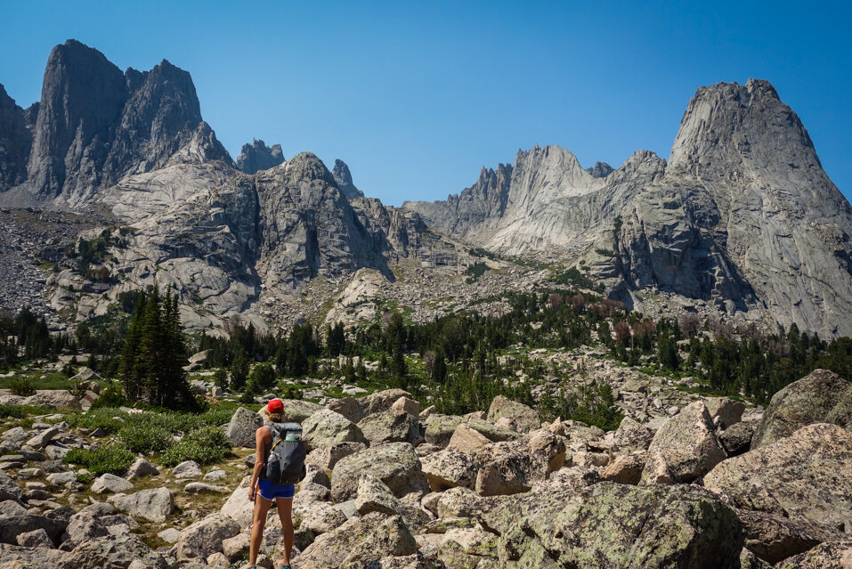 a backpacker looking at the cirque of the towers