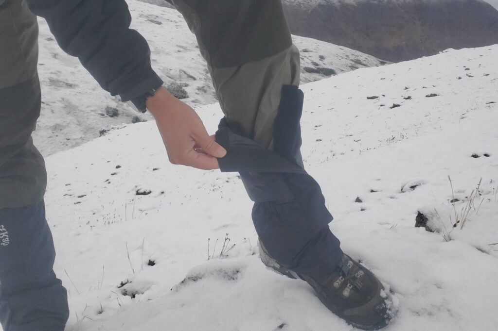 A man adjusts his gaiters