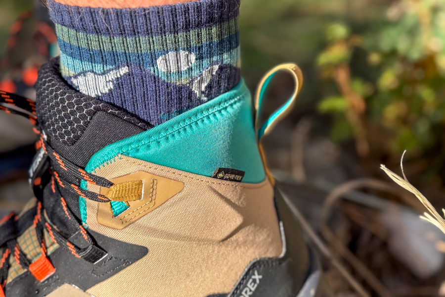 Detailed view of the GORE-TEX label and ankle cuff of the Adidas Terrex Skychaser AX5 Mid GTX Climawarm+ , showing construction materials and stitching.