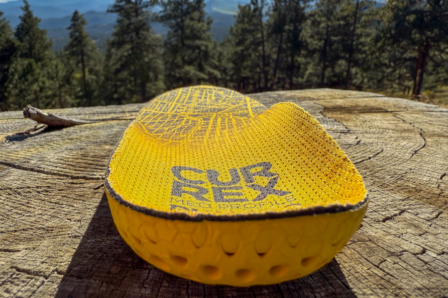 Close-up of the Currex RunPro insole from the heel, showcasing its deep cup and textured yellow base.