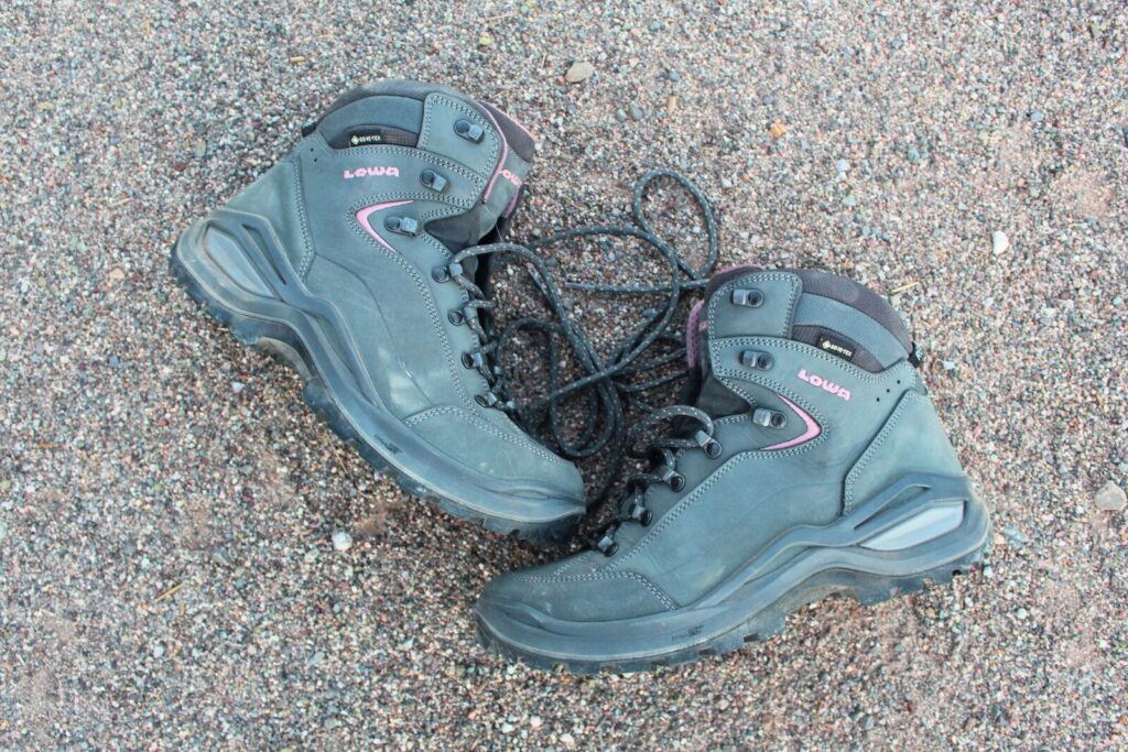Side view of the Lowa Renegade EVO GTX WS while they're laying on a dirt background