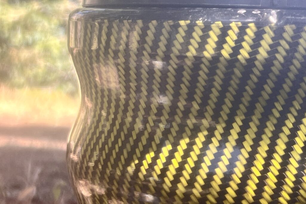 a close up of the texture of a carbon fiber bear canister