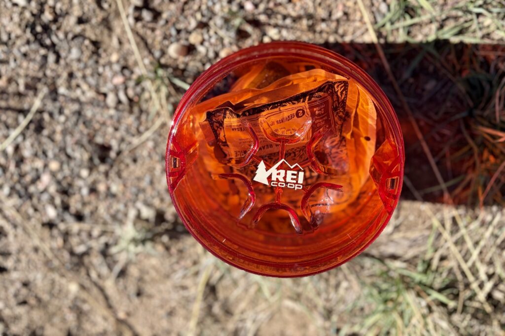 a top down view of an orange bear canister filled with food