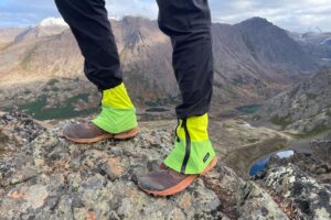 A closeup of hikng giaters with a mountainous background.