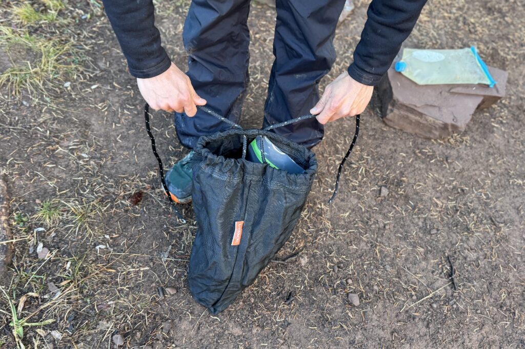 a hiker cinches an ursack closed