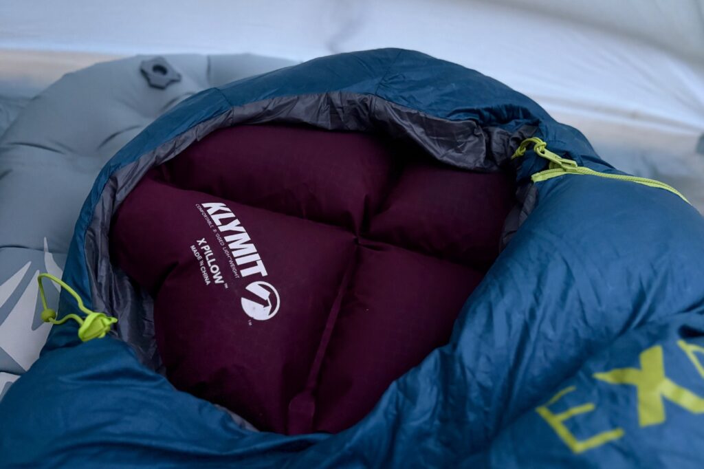 a close up of a small inflatable pillow inside the hood of a sleeping bag
