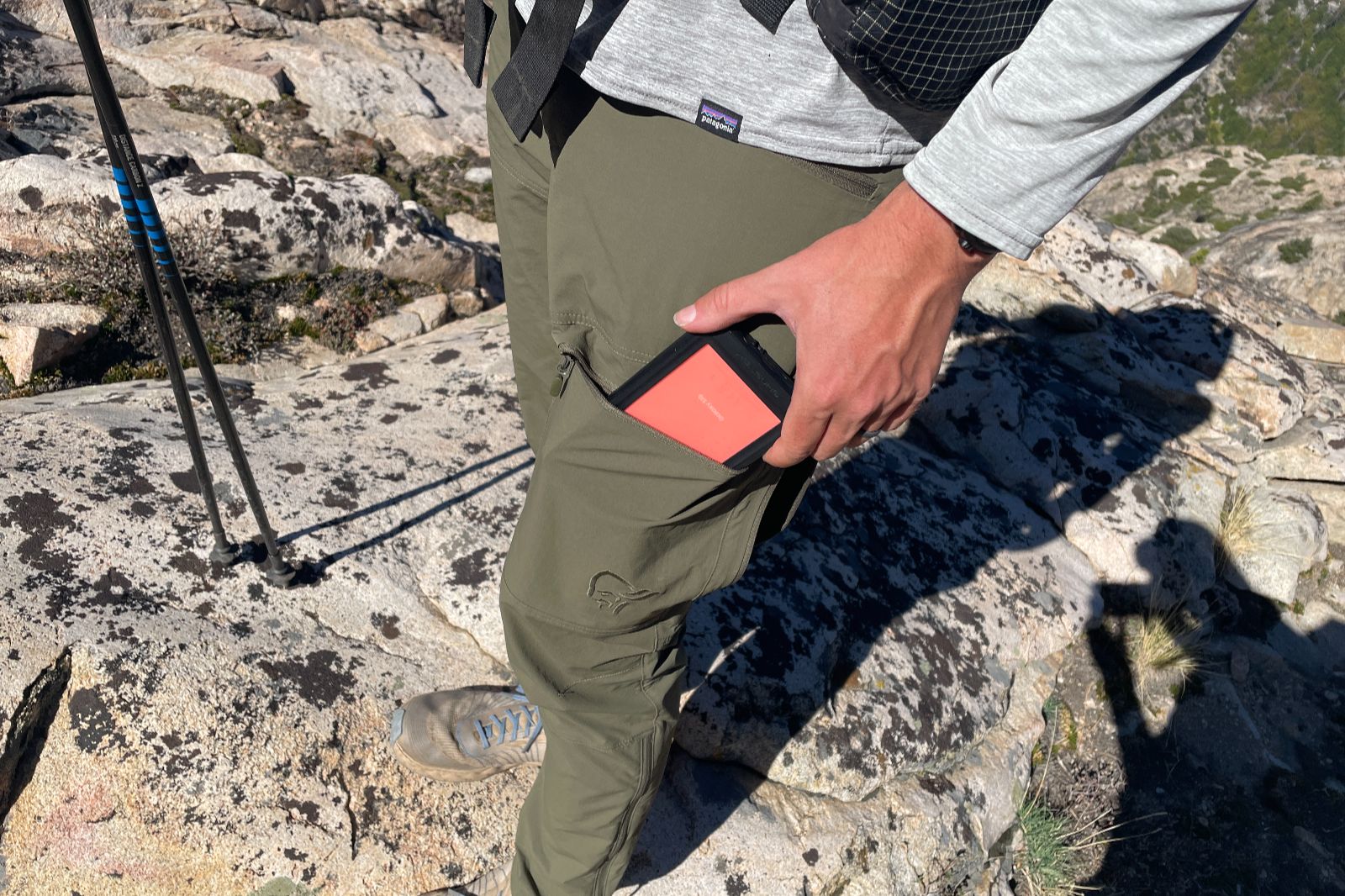 A closeup of the thigh pocket on a pair of green hiking pants.