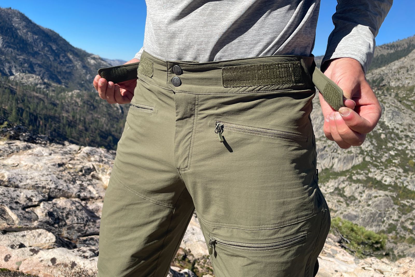 A closeup of the velcro adjustment tabs on a pir of hiking pants.