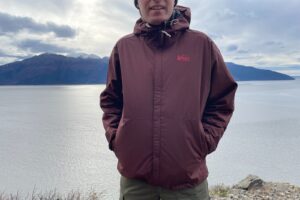 A closeup of the front of a maroon rain jacket.