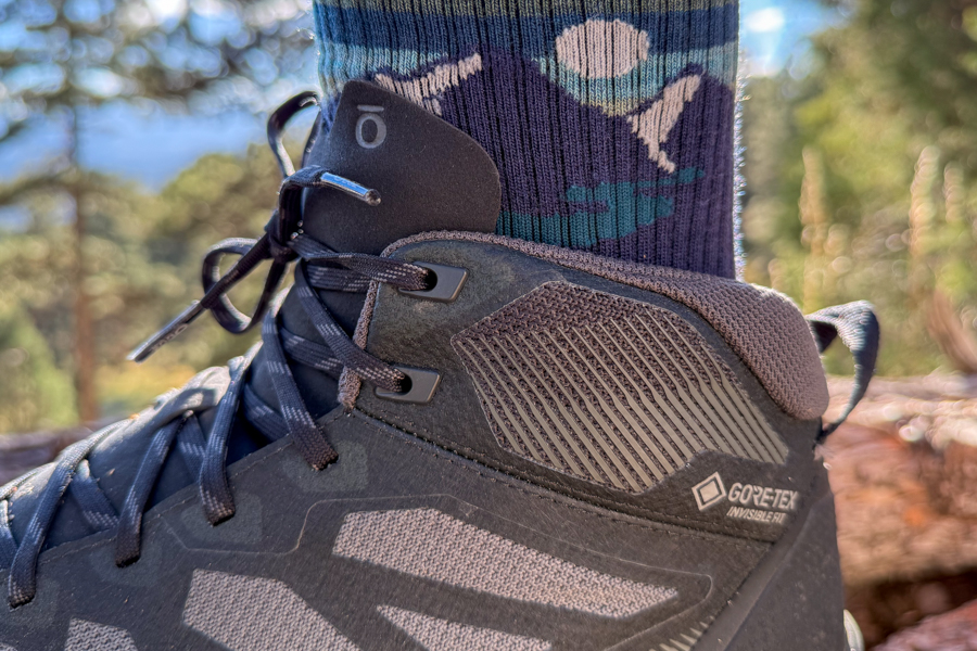 Close-up of the ankle collar and GORE-TEX Invisible Fit label on the Oboz Katabatic LT Mid, emphasizing waterproof construction and padded heel support.