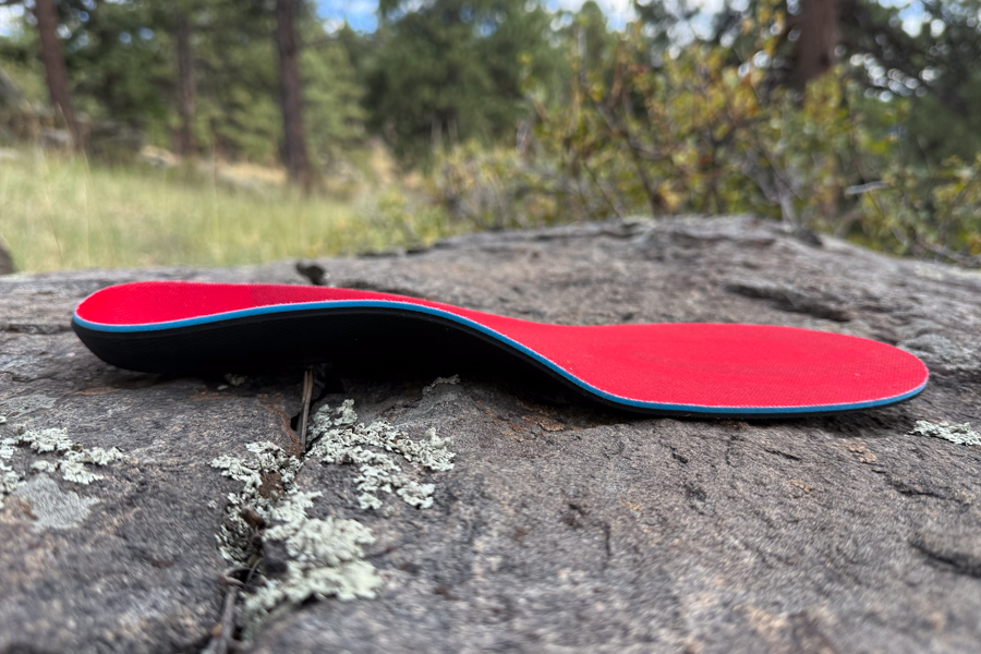 Side view of a SOLE Active Medium insole on a rock, highlighting the defined arch and overall contour.